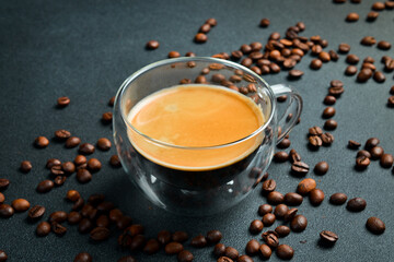 Obraz na płótnie Canvas Glass Cup of Espresso coffee. Top view, on a black background, free copy space. Natural coffee.