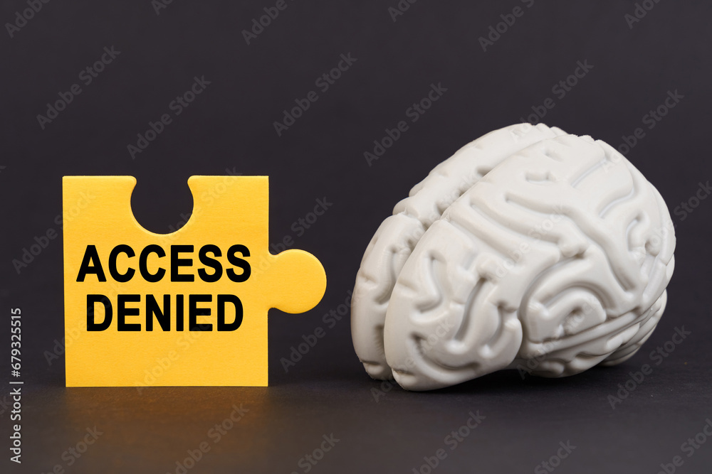 Aufkleber On a black surface there is a brain and a yellow puzzle with the inscription - access denied
