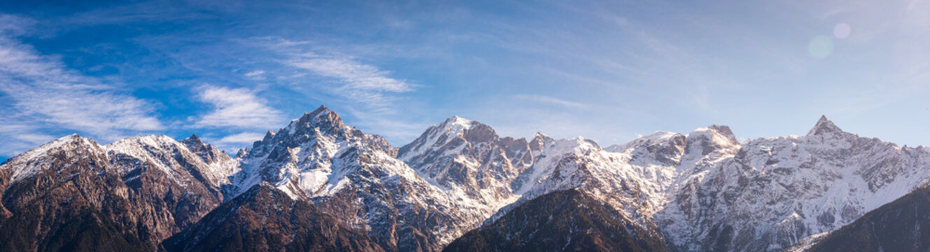 Panoramic view during sunset over snow cladded Kinner kailash mountain peaks falls in Greater Himalayas mountain range from Kalpa village, Kinnaur, Himachal Pradesh, India.