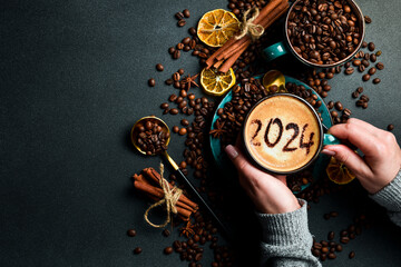 Cup of cappuccino with cinnamon. New Year's decor. Numbers 2024. On a dark background. - obrazy, fototapety, plakaty