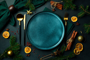 Festive Christmas table setting. A plate with festive cutlery on the table. Free copy space. Top...