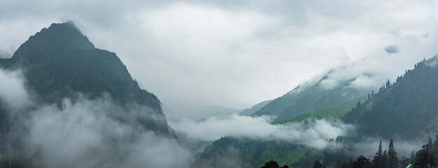 Serene Landscape cloud shrouded mountains of Pir panjal range near Atal Tunnel in Manali of...