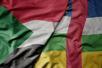 Obraz premium big waving national colorful flag of sudan and national flag of central african republic .