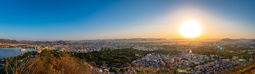 Panoramic aerial view of Udaipur city also known as city of lakes from  Karni Mata Temple, Rajasthan. Udaipur city is a popular honeymoon destination among tourist in India.