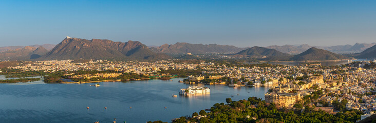 Fototapeta na wymiar Panoramic aerial view of Udaipur city also known as city of lakes from Karni Mata Temple, Rajasthan. Udaipur city is a popular honeymoon destination among tourist in India.