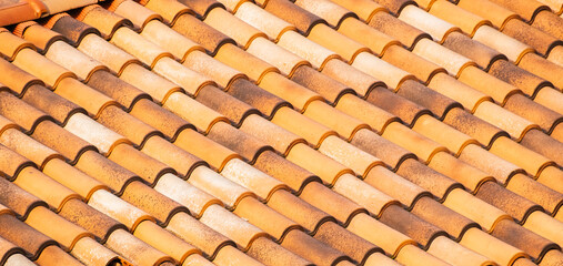 Spanish Tiles for roof. Red roof tiles on house as background image. Shingles roofing surface tiles overlay pattern