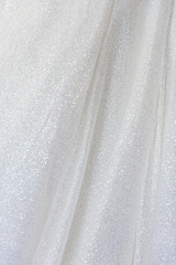white fabric background with bright sequins