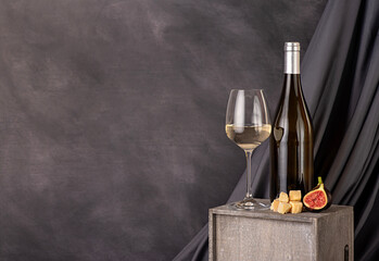 Food photography of white wine; cheese; parmesan; fig; slice; wineglass; bottle; chardonnay,...