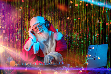 DJ Santa Claus mixing tracks in a nightclub at a Christmas and New Year party or Corporate events....