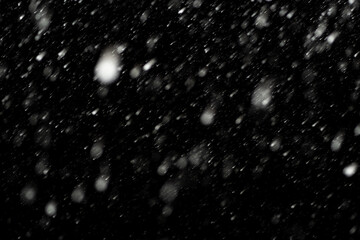Bokeh effect of snowfall and lights. Abstract blurred background with snowflake in the night sky,...