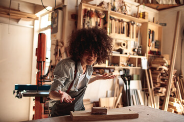 Joyful Woodworker Dancing in Her Craft Studio - obrazy, fototapety, plakaty
