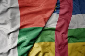 big waving national colorful flag of madagascar and national flag of central african republic .