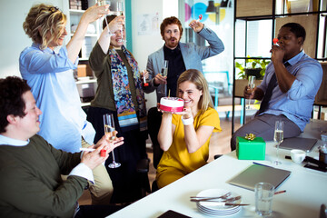 Office Celebration: Joyful Team Toasting with Champagne and a Birthday Cake