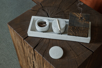 Burning aromatic incense smoky stick for meditation and relaxing on wooden minimalistic background. Aromatherapy smoke for yoga concept.