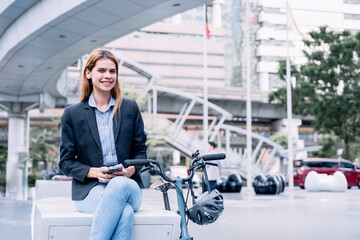 Business woman with bicycle to work on urban street in city. Transport and healthy lifestyle concept. american woman riding a bicycle on a road in a city street. woman with bicycle in modern city.