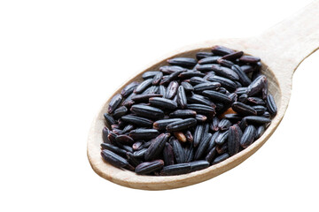 Black wild rice in a wooden spoon. Rural textile background.
