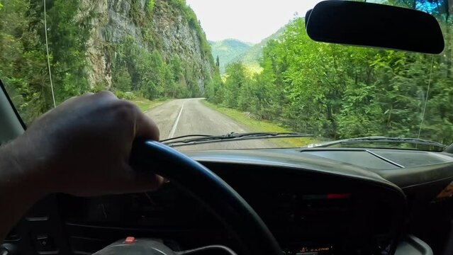 A car is driving on a forest road, view from the salon