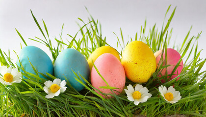 colored easter eggs lying in the grass on a white background