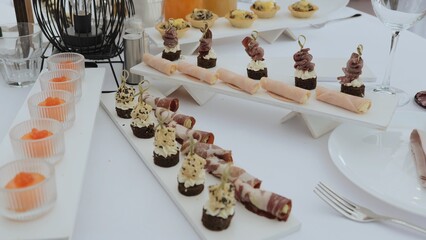 Catering on a banquet table with appetizers-canapes in a restaurant or hotel. Snacks on the table, catering concept. buffet food set for corporate day celebration.