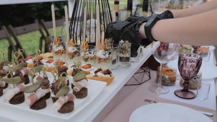 Business lunch. A beautiful festive table covered with a variety of food. Food and drinks on the festive table in the restaurant. Beautifully decorated banquet table with appetizers.