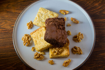 Stack of some pieces of brownies of white and dark chocolate.
