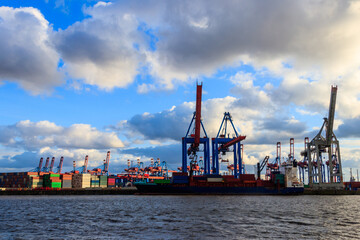 Fototapeta na wymiar Port of Hamburg with loading cranes on the river Elbe in Hamburg, Germany