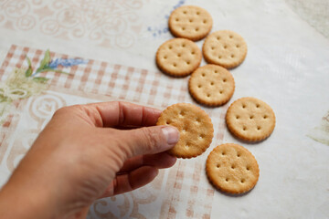 Cookie crackers with salt in arm close