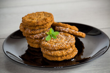 cooked sweet oatmeal cookies on wooden table