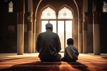 Muslim father and his son pray the koran in a mosque
