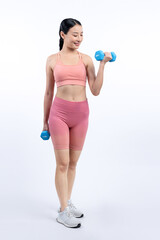 Fototapeta na wymiar Vigorous energetic woman doing dumbbell weight lifting exercise on isolated background. Young athletic asian woman strength and endurance training session as body workout routine.