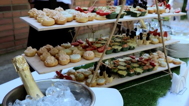 Catering on a banquet table with appetizers-canapes in a restaurant or hotel. Snacks on the table, catering concept. buffet food set for corporate day celebration.
