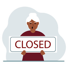 A woman holds a sign with the text Closed in his hands.