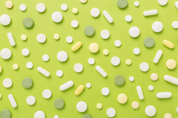 Flat lay with different medical pills and capsules on color background