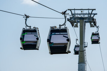Cable Car in landscape park. Transport tourists uphill, cableway cabins. Ropeway, aerial lift