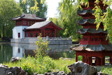 Japanese garden with pagoda and pond in summer.