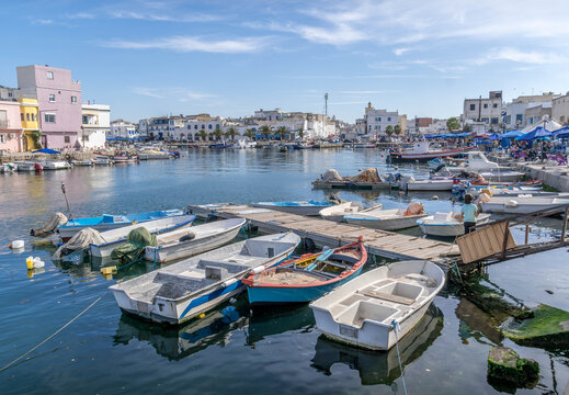 The boats and piers are at the Bizerte port harbor on the Mediterranean sea, with the houses along the promenade at north of Tunisia.