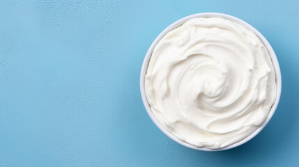 Bowl of tasty sour cream on wooden table