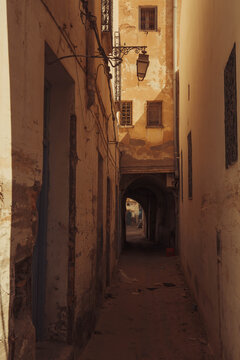 The narrow street with the lamp and small windows at old town (Medina) of Kairouan, Tunisia, in the Maghrib region of Africa.