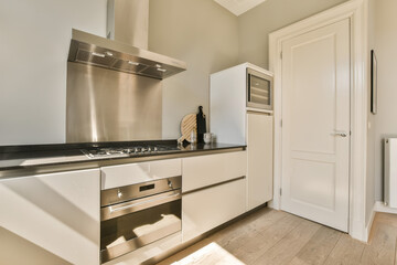 a kitchen with white cabinets and stainless steel appliances on the counter top in this photo is taken from the inside