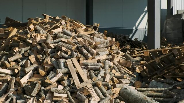 Stacking Firewood. Pile of firewood loggs. Preparation for winter heating season. Firewood background