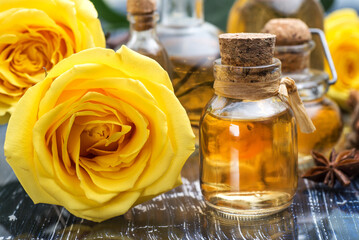 yellow rose flower and essential oil in a glass bottle. spa and aromatherapy. close-up.