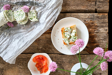 sandwich with chives butter, chives, salmon. Wooden background, top view