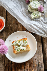 sandwich with chives butter, chives, salmon. Wooden background, top view