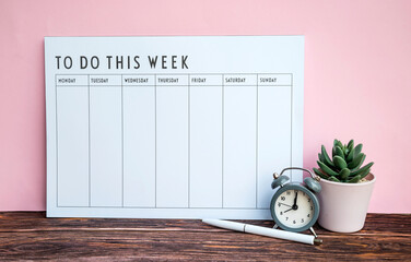 Weekly planner on pink background . To do this week 