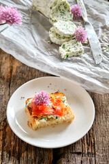 sandwich with chives butter, chives, salmon. Wooden background, top view