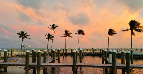 Wooden piers fit perfectly into the relaxing atmosphere of a picturesque sunset in a tropical...