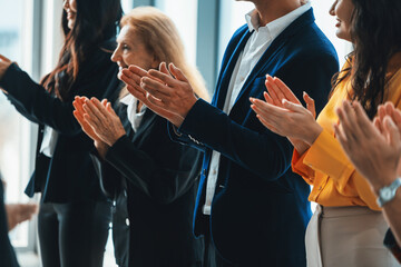 Group of business people clapping hands at successful presentation or conference. Cropped image...