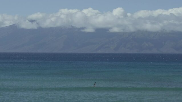 Stand up paddle board surfer paddling looking for waves