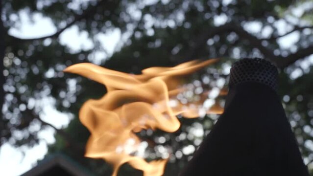 Tiki torch burning in slow motion close up