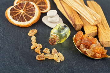 Fototapeta premium Smudge kit for spiritual practices with natural elements: Palo Santo sticks, dried orange fruit slices, SPA stones, essence and resin.